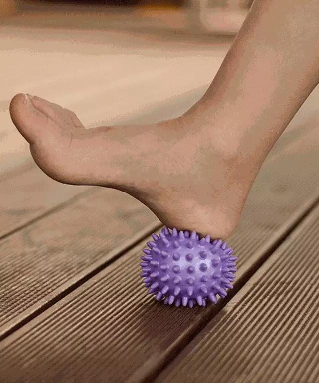 Foot heel on purple ball
