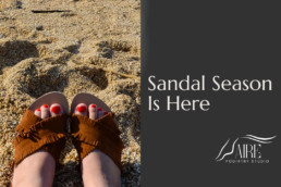 Feet in sandals on beach